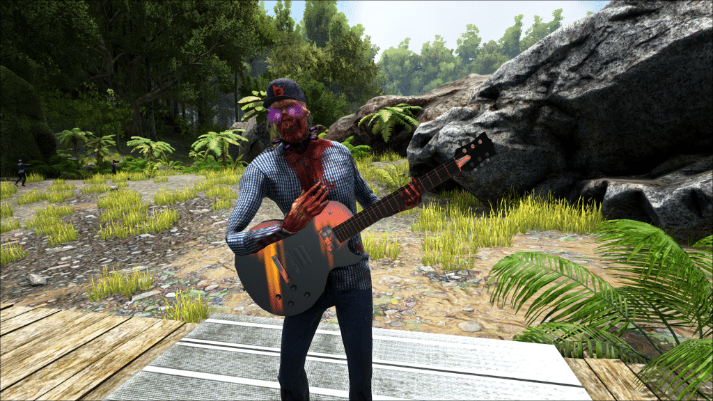 A captive zombie plays guitar